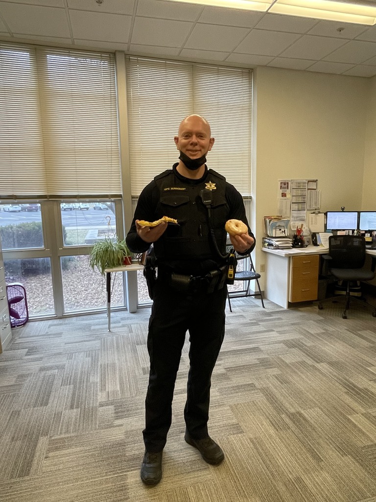 Officer Sunnquist with pizza and donuts
