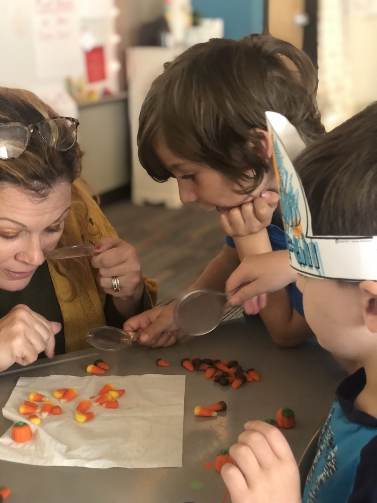 Using magnifying glass to look at autumn candy