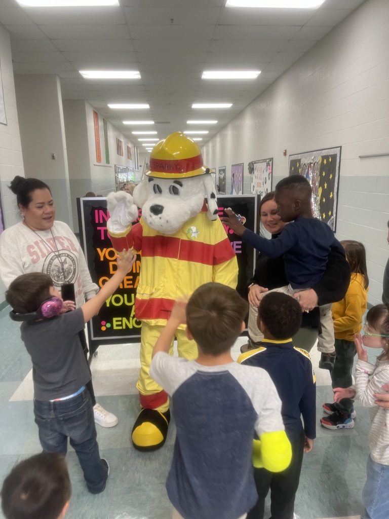 Sparky stopping to say hi to students in Mrs. Knolhoff's room.