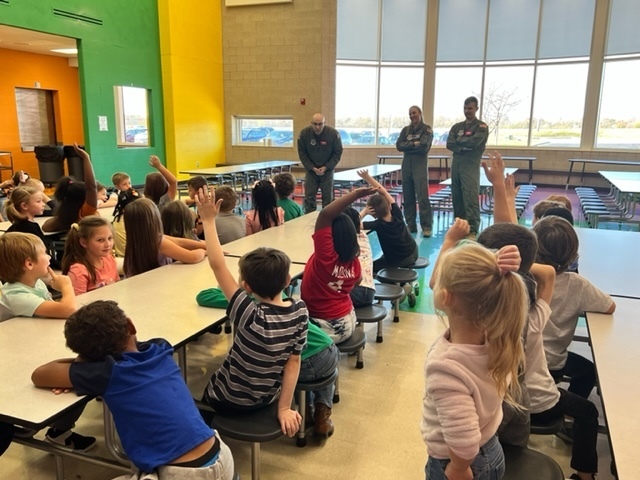service men talking to students