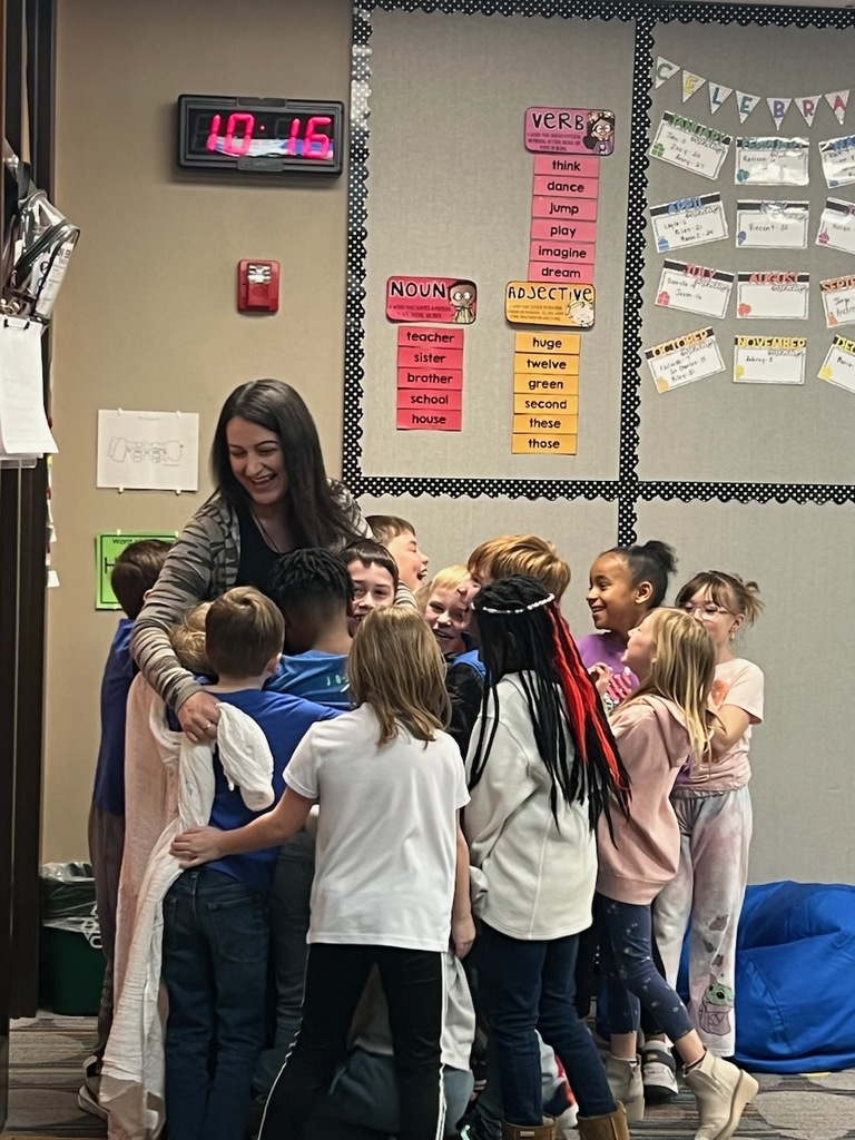 Students presenting Mrs. Gardner with her new baby blanket.