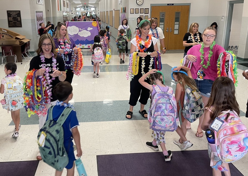 Staff greeting students with leis